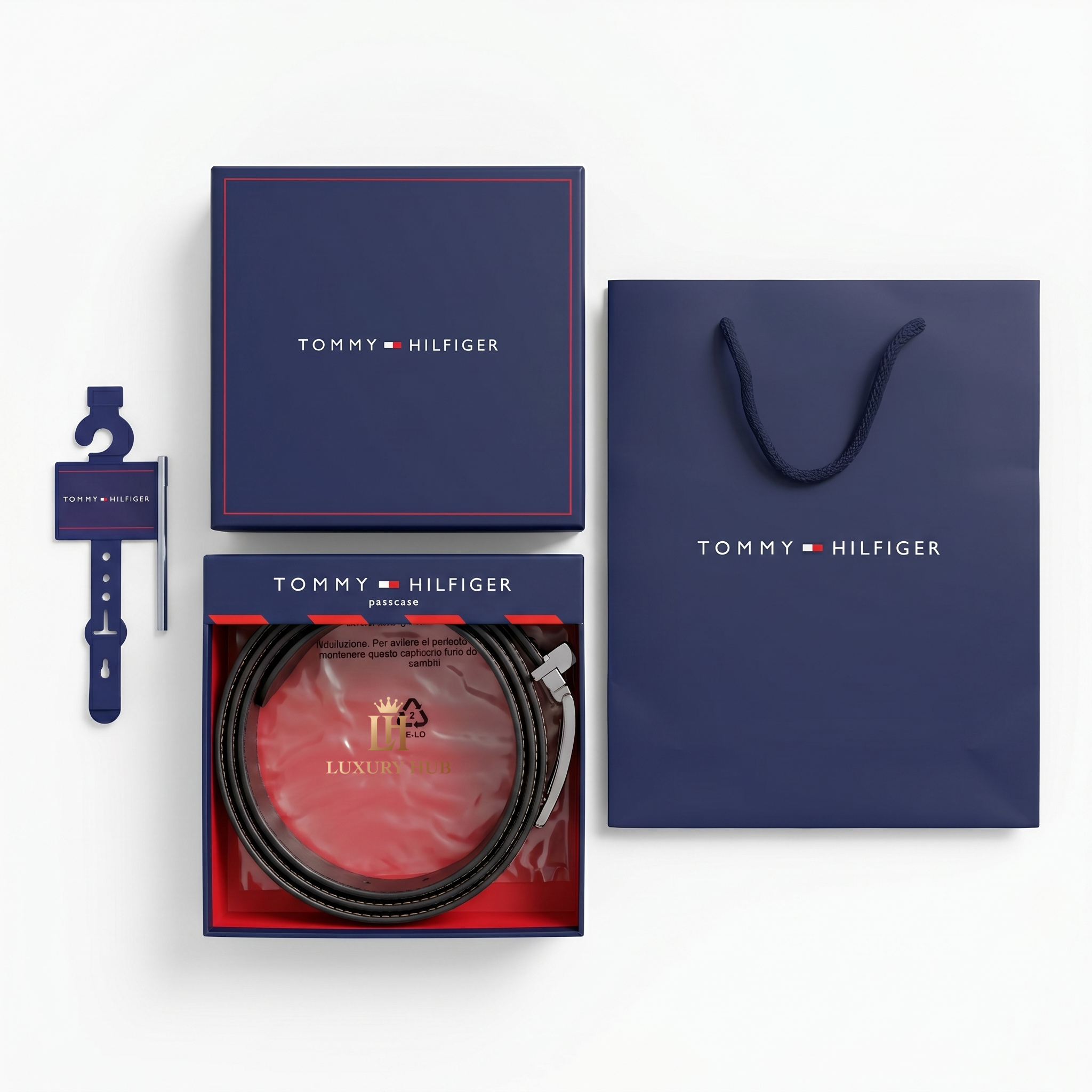 Top view product photography of the Tommy Hilfiger reversible leather belt set presented in its signature navy gift box