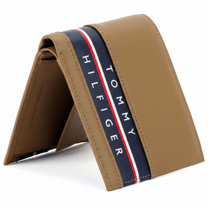 High-detail close-up of the navy blue branding stripe on a tan Tommy Hilfiger genuine leather wallet