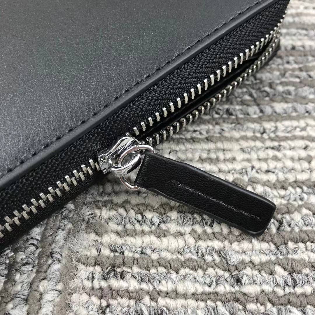 Close up of leather zipper pull and metal teeth on Tommy Hilfiger Zip-Around Wallet