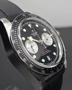 Tudor Black Bay Chrono men's chronograph watch, 41mm stainless steel case, black dial, black rubber strap – angle view