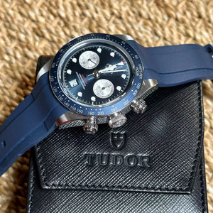 Tudor Black Bay Chrono men's chronograph watch, 41mm stainless steel case, blue dial, blue rubber strap – angle view with pouch