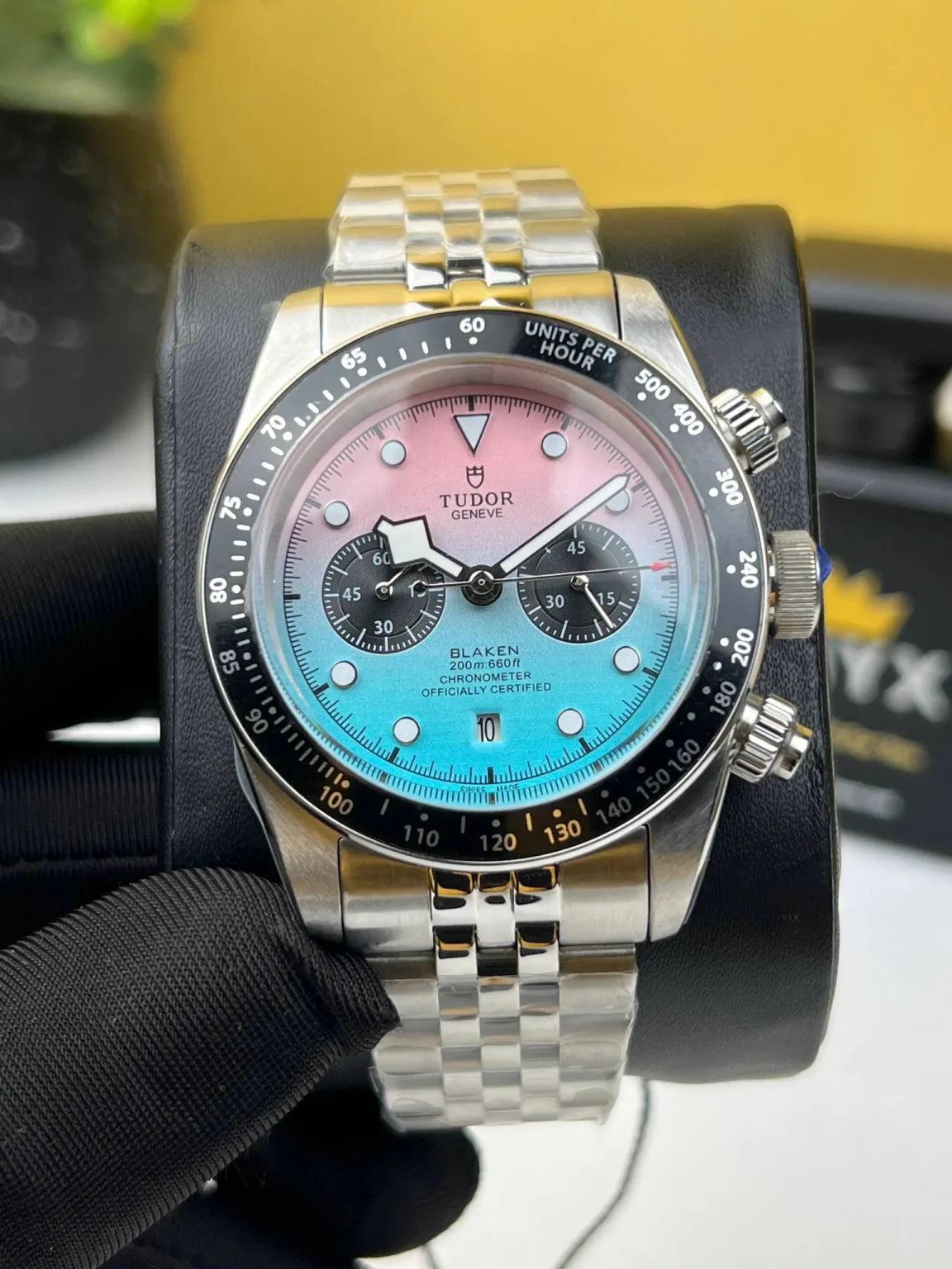 Tudor Black Bay Chrono men's chronograph watch, 41mm stainless steel case, pink and turquoise gradient dial, steel bracelet – front view on display
