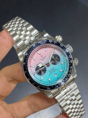 Tudor Black Bay Chrono men's chronograph watch, 41mm stainless steel case, pink and turquoise gradient dial, steel bracelet – hand-held view