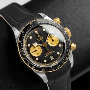 Tudor Black Bay Chrono S&G men's chronograph watch, 41mm steel and yellow gold case, champagne chronograph counters, black rubber strap – left angle view