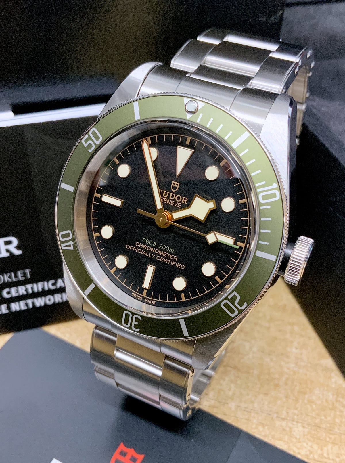 Tudor Black Bay Harrods Edition M79230G-0001 men's automatic dive watch, 41mm stainless steel case, black dial, green bezel, steel bracelet – angle view on display