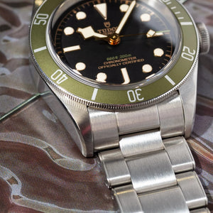 Tudor Black Bay Harrods Edition M79230G-0001 men's automatic dive watch, 41mm stainless steel case, black dial, green bezel, steel bracelet – side angle close-up