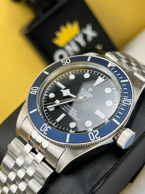Tudor Black Bay M79230B-0008 men's automatic dive watch, 41mm stainless steel case, black dial, blue bezel, steel bracelet – angle view