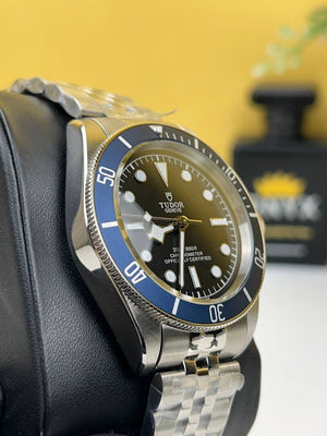 Tudor Black Bay M79230B-0008 men's automatic dive watch, 41mm stainless steel case, black dial, blue bezel, steel bracelet – left angle view