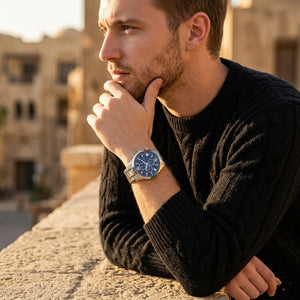 Elegant man wearing Guess Hudson W0875G1 men's quartz battery watch with silver case and luxury silver metal bracelet