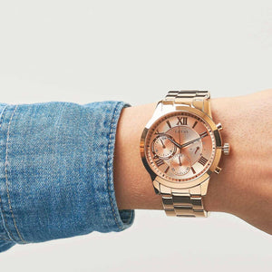 Wrist shot of Guess Solar W1070L3 watch showing the rose gold metal band