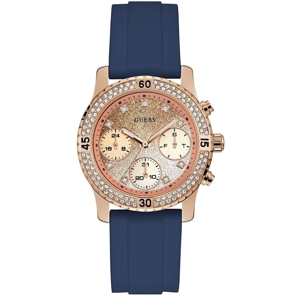 Guess Confetti Multi-Function W1098L6 women's watch with cushion-shaped gold-tone case, dynamic bezel embellished with crystals and screw details, deep navy blue dial with luminous yellow gold hands and indices, and integrated flexible navy blue silicone rubber strap main view