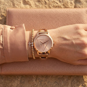 Close up of Guess W1145L4 women's quartz battery watch on wrist showing iconic triangle question mark logo dial
