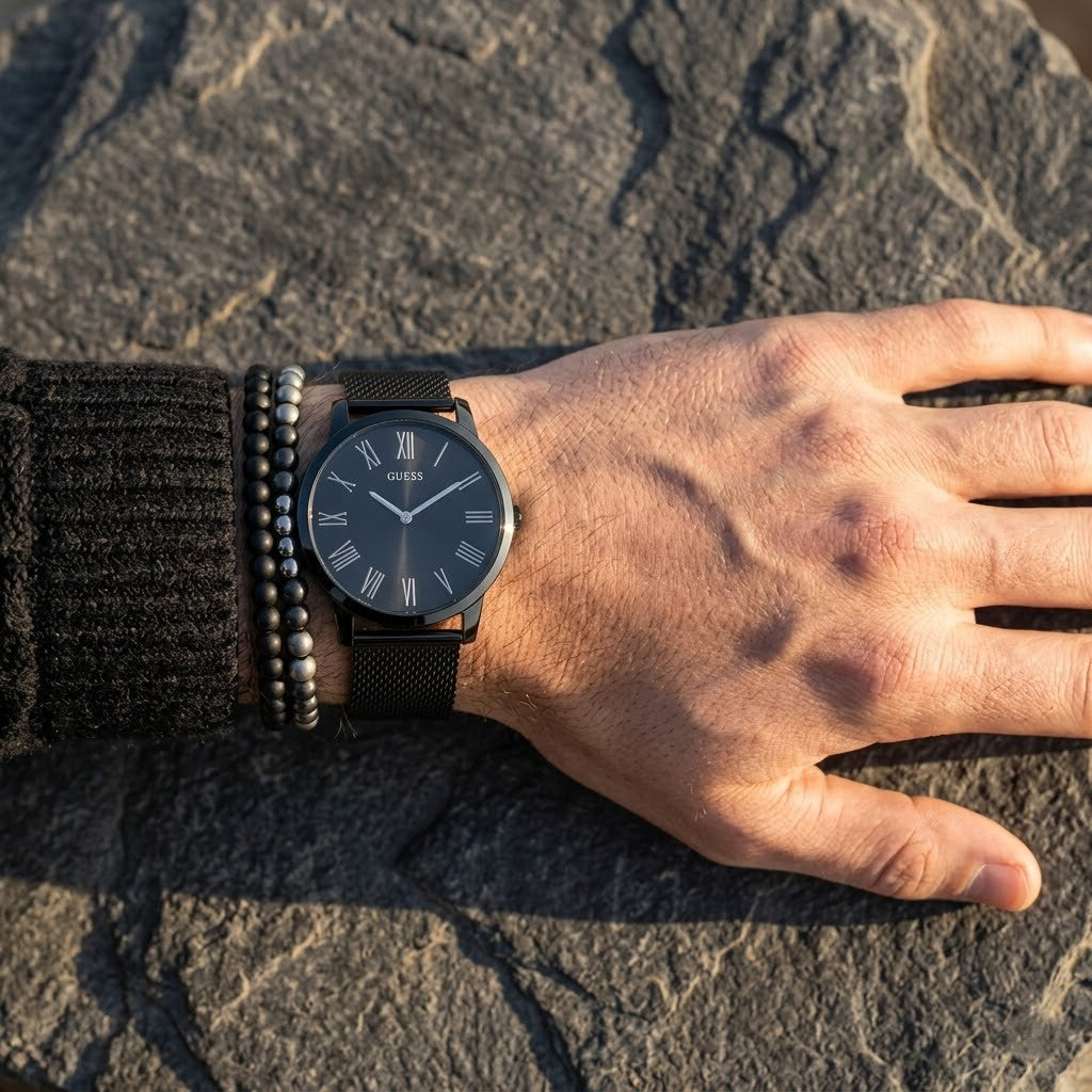 Close up of Guess Richmond W1263G3 men's quartz battery watch on wrist showing clean black dial and roman numerals