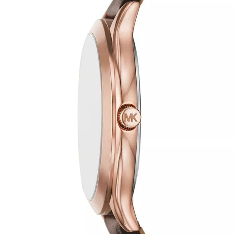 Close-up side view of a Michael Kors watch with a rose gold case, brown leather strap, and a white dial on a white background.